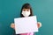 Thai girl with cute face Wear a white mask on the face to prevent toxic dust and the COVID-19 virus. Epidemic Her hand holding a w