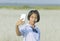 Thai girl student taking selfie at the white meadows