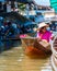 Thai locals sell food and souvenirs at famous Damnoen Saduak floating market, Thailand