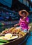 Thai locals sell food and souvenirs at famous Damnoen Saduak floating market, Thailand