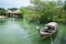 Thai long tail boat with mangrove and huts view