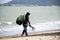 Thai man athletes walking on sand beach and carry kiteboard go to practicing sports and playing or sea kite at Ban Pae beach