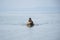 Thai man fisher people sailing wooden long tail boat fishery after catch fish and marine life in ocean of Phetra National Park to