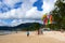 Thai man taking off with parasail at sunset on Patong beach Phuket