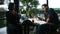 Thai man and woman sit relax and talking with drinking ice coffee in cafe shop