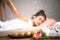 Thai Masseuse doing massage for woman in spa salon. Asian beautiful woman getting thai herbal massage compress massage in spa.She