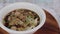 Thai meat ball noodle soup in a white bowl , rotating in a wooden plate, Thai style ready meal