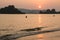 Thai men setting fishing nets before low tide at sunset