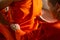 Thai monk help to wear orange monk cloth to buddhist