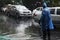 Thai officer operator volunteer staff wear rain suit working control and take care traffic road while raining strom on street at