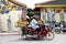 Thai old men riding motorcycle cart and sidecar trash keeper and pickup recyclable waste go to sale at Waste recycling shop on
