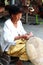 Thai Old woman weaving bamboo baskets