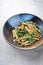 Thai Pad See Ew Noodles with vegetable and minced beef in a modern design bowl