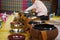 Thai people put food offerings of tradition of almsgiving with sticky rice and food to Buddhist alms bowl at Retro house on