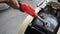 Thai people use gas pump nozzle filling gasoline fuel to tank of motorcycle