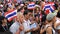 Thai protesters raise thai flag and blow whistles