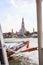 Thai riverside transportation in Chao Phraya River with Wat Arun Buddhist Temple of Dawn background, Bangkok. Traditional