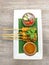 Thai satay chicken skewers with peanut sauce on plate covered by banana leaf