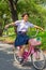 Thai Schoolgirl playing risky on a bicycle, in the park.