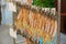 Thai street food, dried squids, orderly clipped and hanged on metal wire