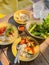 Thai street food. Traditional Thai red curry with king prawns, rice and fresh vegetable on wooden table