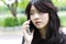 Thai student teen beautiful girl Answer the phone and smile