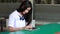 Thai student teen beautiful girl typing tablet.