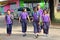 Thai students are walking on cement road.