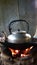 Thai-style charcoal stove with kettle placed on top located in the kitchen.