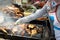 Thai style Isaan street food vendor cart,grilled chicken,catfish and grilled chicken liver on a charcoal stove with smoke at