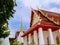 Thai temple with 2 levels roof with golden top pagodas.