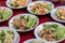 Thai tradition food. Spicy minced pork salad  in white plate on wooden table. Popular with sticky rice and papaya salad. Thai sty