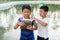 Thai twin boy prepare for feed fish.