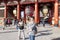 Thai woan is taking photo in front of Asakusa entrance and pagoda with a flock of Japanese people behind. Tokyo, Japan February 7