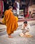 Thai woman gave aims and offering food to the monk.