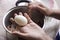 Thai woman peeling boiled egg for cooking