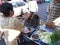 Thai woman selling cooked sausages, Thailand.