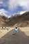 Thai woman travel visit and take photo on Pangong lake road with himalayan mountains at Leh Ladakh in Jammu and Kashmir, India