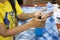 Thai woman working sewing fabric mask and use alcohol gel cleaning hand and product before start work at workshop in house at