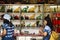 Thai women select and buy holy amulet and jade accessory form talismans souvenir shop of Kaiyuan Temple at Teochew in Guangdong