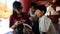 Thai women teach burmese children reading book at Shwezigon Pagoda