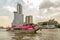 Thailand, Bangkok, February 1, 2019: Tourist boat with tourists floating on the muddy river of Bangkok on the background of a