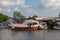 Thailand - January 31, 2018: An old rusty ship stands near the shore on a river.