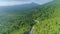 Thailand jungle road aerial: mountains peaks with lush green trees foliage. Epic nature landscape