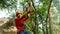 Thailand, Koh Samui, 26 january 2016. Canyoning instructor explains how to hold onto a slingshot on a cable descent in