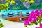 Thailand Phi Phi island beach bay with longtail boats and blooming bougainvillea flowers, Asia travel landscape