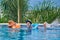 THAILAND PHUKET, 20 MARCH 2018-Mom with little daughter in inflatable armbands and swim around in outdoor pool, background of palm