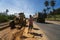 THAILAND, PHUKET - December 12, 2018: Women working on a road construction site. Grader is working on road construction