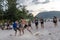 Thailand, Phuket, March 30, 2020: Asian boys and girls, maybe Chinese, playing soccer on the beach by the sea at sunset