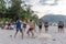 Thailand, Phuket, March 30, 2020: men and teenage girls from China play soccer and Rugby with a ball on the beach. sharp